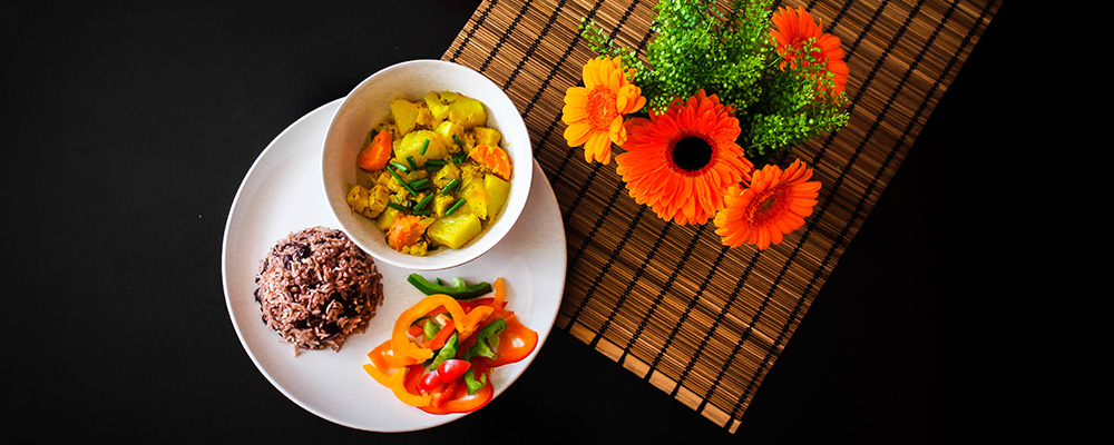 Curried vegetables with rice & peas and a pepper garnish