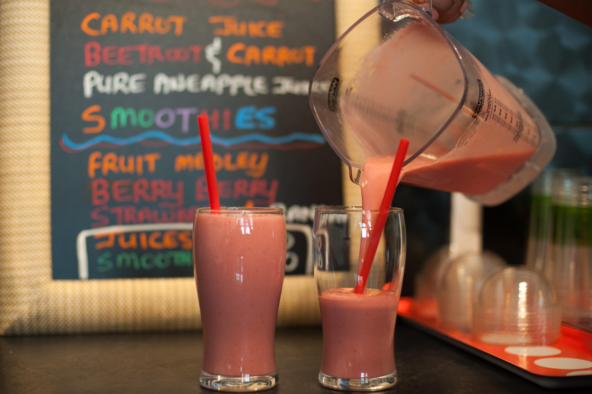 Fresh fruit smoothies poured at the counter